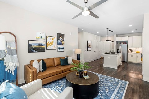 a living room with a couch and a ceiling fan